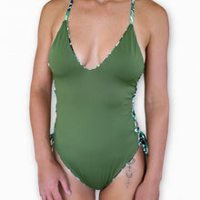 Load image into Gallery viewer, Meli reversible one piece with details on the side. Model is wearing a small.
